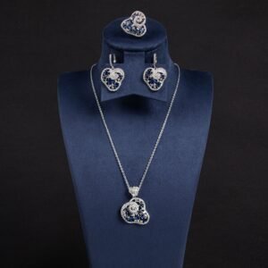 Niche swirl heart crystal jewelry set wholesale featuring an openwork filigree swirl heart pendant necklace, statement ring, and matching drop earrings studded with cubic zirconia from junejewelry.com