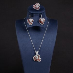 Niche swirl heart crystal jewelry set wholesale featuring an openwork filigree swirl heart pendant necklace, statement ring, and matching drop earrings studded with cubic zirconia from junejewelry.com