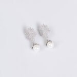 Enhance your online inventory with romantic elegance by adding our Floral pearl drop jewelry set wholesale, available at junejewelry.com. As shown in image LY5561 (4).jpg, this two-piece set artfully combines delicate botanical brilliance with classic luster. Built on an eco-friendly, tarnish-resistant platinum-plated copper base (100% lead, nickel, and cadmium free), each piece features a detailed cluster of tiny pave-set cubic zirconia blossom flowers anchored by a luminous, dangling synthetic pearl drop, paired with matching cluster drop earrings. Presented in brilliant Crystal Clear, this whimsical floral set elevates everyday commuting ensembles, wedding celebrations, formal banquets, and travel wardrobes alike. B2B buyers enjoy exceptional high quality craftsmanship at a cheap factory price designed to maximize retail margins. Order directly on junejewelry.com to benefit from export-grade packaging and free shipping on qualifying bulk wholesale purchases!