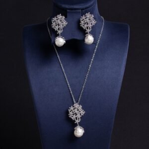 Enhance your online inventory with romantic elegance by adding our Floral pearl drop jewelry set wholesale, available at junejewelry.com. As shown in image LY5561 (4).jpg, this two-piece set artfully combines delicate botanical brilliance with classic luster. Built on an eco-friendly, tarnish-resistant platinum-plated copper base (100% lead, nickel, and cadmium free), each piece features a detailed cluster of tiny pave-set cubic zirconia blossom flowers anchored by a luminous, dangling synthetic pearl drop, paired with matching cluster drop earrings. Presented in brilliant Crystal Clear, this whimsical floral set elevates everyday commuting ensembles, wedding celebrations, formal banquets, and travel wardrobes alike. B2B buyers enjoy exceptional high quality craftsmanship at a cheap factory price designed to maximize retail margins. Order directly on junejewelry.com to benefit from export-grade packaging and free shipping on qualifying bulk wholesale purchases!