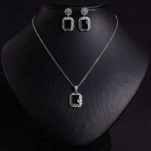 Niche emerald cut crystal jewelry set wholesale featuring a radiant halo CZ rectangular crystal pendant chain necklace and matching drop earrings from junejewelry.com
