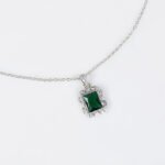 Niche emerald cut crystal jewelry set wholesale featuring a radiant halo CZ rectangular crystal pendant chain necklace and matching drop earrings from junejewelry.com