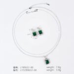 Niche emerald cut crystal jewelry set wholesale featuring a radiant halo CZ rectangular crystal pendant chain necklace and matching drop earrings from junejewelry.com