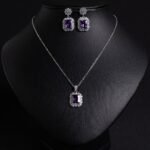 Niche emerald cut crystal jewelry set wholesale featuring a radiant halo CZ rectangular crystal pendant chain necklace and matching drop earrings from junejewelry.com