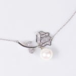 Light luxury rose pearl necklace wholesale featuring a pave CZ rose flower branch with a dangling white pearl pendant chain necklace from junejewelry.com