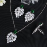 Niche feather crystal cluster jewelry set wholesale featuring marquise CZ leaf cluster pendants topped with pear-cut colored gemstones with matching earrings and ring from junejewelry.com
