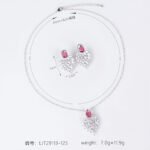 Niche feather crystal cluster jewelry set wholesale featuring marquise CZ leaf cluster pendants topped with pear-cut colored gemstones with matching earrings and ring from junejewelry.com