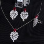 Niche feather crystal cluster jewelry set wholesale featuring marquise CZ leaf cluster pendants topped with pear-cut colored gemstones with matching earrings and ring from junejewelry.com