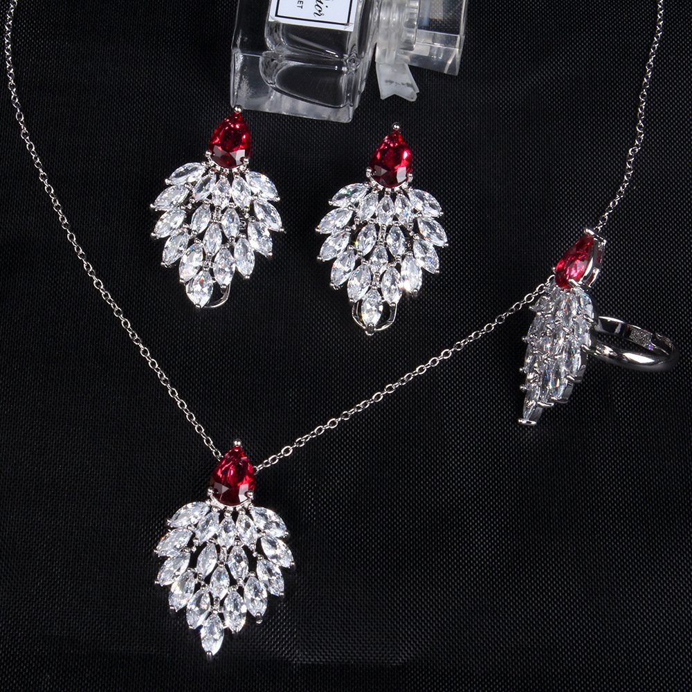 Niche feather crystal cluster jewelry set wholesale featuring marquise CZ leaf cluster pendants topped with pear-cut colored gemstones with matching earrings and ring from junejewelry.com