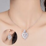 Niche feather crystal cluster jewelry set wholesale featuring marquise CZ leaf cluster pendants topped with pear-cut colored gemstones with matching earrings and ring from junejewelry.com