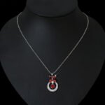 Niche butterfly crystal necklace wholesale featuring a marquise cubic zirconia butterfly top with a micro-pave crescent hoop and suspended solitaire CZ stone from junejewelry.com