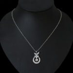 Niche butterfly crystal necklace wholesale featuring a marquise cubic zirconia butterfly top with a micro-pave crescent hoop and suspended solitaire CZ stone from junejewelry.com