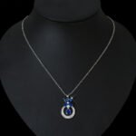 Niche butterfly crystal necklace wholesale featuring a marquise cubic zirconia butterfly top with a micro-pave crescent hoop and suspended solitaire CZ stone from junejewelry.com