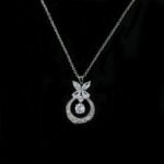 Niche butterfly crystal necklace wholesale featuring a marquise cubic zirconia butterfly top with a micro-pave crescent hoop and suspended solitaire CZ stone from junejewelry.com