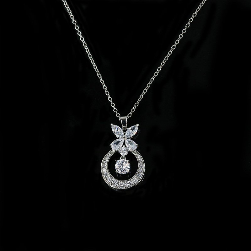 Niche butterfly crystal necklace wholesale featuring a marquise cubic zirconia butterfly top with a micro-pave crescent hoop and suspended solitaire CZ stone from junejewelry.com
