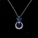Niche butterfly crystal necklace wholesale featuring a marquise cubic zirconia butterfly top with a micro-pave crescent hoop and suspended solitaire CZ stone from junejewelry.com