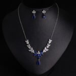 Niche vine crystal drop jewelry set wholesale featuring a marquise cubic zirconia leaf garland necklace with a dangling teardrop gem pendant and matching teardrop earrings from junejewelry.com