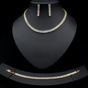 Baguette CZ tennis jewelry set wholesale including necklace, drop earrings, and tennis bracelet featuring emerald-cut cubic zirconia on 18K gold and palladium plated copper.
