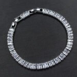 Baguette CZ tennis jewelry set wholesale including necklace, drop earrings, and tennis bracelet featuring emerald-cut cubic zirconia on 18K gold and palladium plated copper.