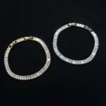 Baguette CZ tennis jewelry set wholesale including necklace, drop earrings, and tennis bracelet featuring emerald-cut cubic zirconia on 18K gold and palladium plated copper.
