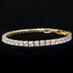 Square CZ V-necklace set wholesale including V-shaped tennis necklace and matching linear dangle drop earrings featuring princess-cut cubic zirconia on 18K gold and palladium plated copper base.