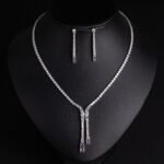 Niche lariat tennis necklace jewelry set wholesale featuring a Y-shaped drop tennis necklace and linear dangle drop earrings with sparkling cubic zirconia accents from junejewelry.com