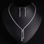 Niche lariat tennis necklace jewelry set wholesale featuring a Y-shaped drop tennis necklace and linear dangle drop earrings with sparkling cubic zirconia accents from junejewelry.com
