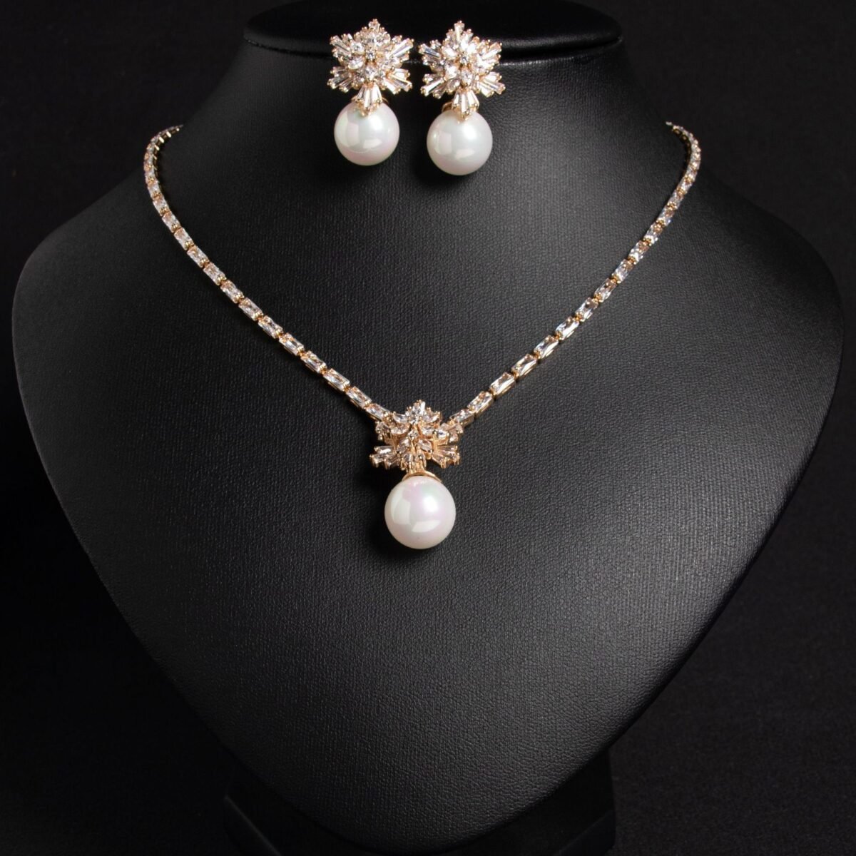 Niche snowflake pearl pendant jewelry set wholesale featuring a cubic zirconia tennis necklace with a snowflake crystal star burst and smooth pearl pendant, paired with matching pearl drop earrings from junejewelry.com