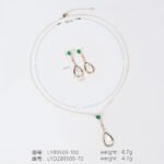 Niche teardrop shell pearl zircon jewelry set wholesale featuring a pear-shaped mother-of-pearl drop topped with a round green agate gem and crystal linear chain, paired with matching drop earrings from junejewelry.com