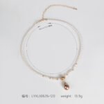 Light luxury tear drop pearl strand necklace wholesale featuring a delicate white pearl bead chain with a pave CZ arched crown connector and large teardrop pearl pendant from junejewelry.com