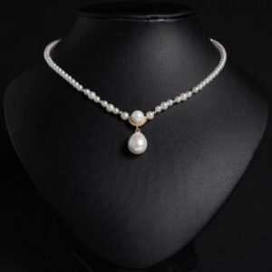 Light luxury tear drop pearl strand necklace wholesale featuring a delicate white pearl bead chain with a pave CZ arched crown connector and large teardrop pearl pendant from junejewelry.com