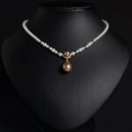 Light luxury tear drop pearl strand necklace wholesale featuring a delicate white pearl bead chain with a pave CZ arched crown connector and large teardrop pearl pendant from junejewelry.com