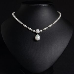 Light luxury tear drop pearl strand necklace wholesale featuring a delicate white pearl bead chain with a pave CZ arched crown connector and large teardrop pearl pendant from junejewelry.com