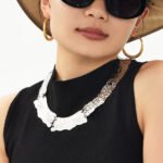 Model wearing 18K gold plated textured curved plate statement collar choker necklace