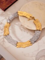 Model wearing 18K gold plated textured curved plate statement collar choker necklace