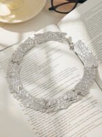 Model wearing 18K gold plated textured curved plate statement collar choker necklace