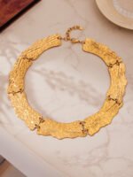 Model wearing 18K gold plated textured curved plate statement collar choker necklace