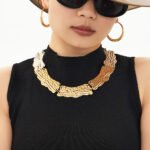 Model wearing 18K gold plated textured curved plate statement collar choker necklace