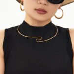 Model wearing 18K gold plated minimalist open wave torque choker necklace