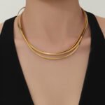 Model wearing gold plated minimalist rigid wire torque collar choker necklace in stainless steel
