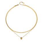 Model wearing double layer gold teardrop pendant necklace with flat snake chain