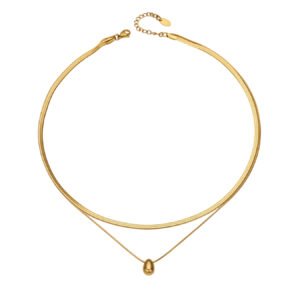 Model wearing double layer gold teardrop pendant necklace with flat snake chain