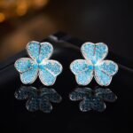 Wholesale turquoise pave earrings collection featuring micro-pave turquoise studs, huggie hoops, pearl drops, swan, and flower designs.