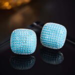 Wholesale turquoise pave earrings collection featuring micro-pave turquoise studs, huggie hoops, pearl drops, swan, and flower designs.