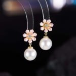 Niche floral charm pearl necklace earring set wholesale featuring alternating enamel flower charms and high-luster round pearl drops along a gold link chain with matching flower pearl drop earrings from junejewelry.com