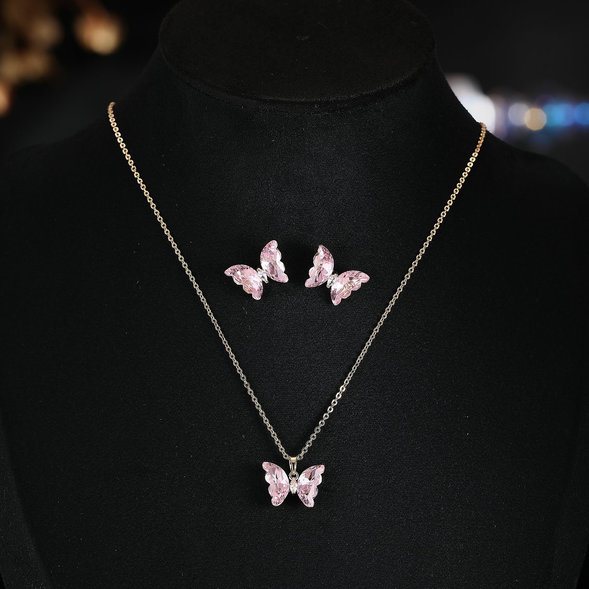 T-035 (10) Niche ice translucent butterfly zircon jewelry set wholesale featuring carved crystal butterfly wings with marquise zircon bodies on a fine chain pendant necklace and matching stud earrings from junejewelry.com