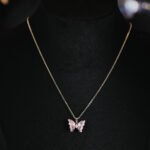 Niche ice translucent butterfly zircon jewelry set wholesale featuring carved crystal butterfly wings with marquise zircon bodies on a fine chain pendant necklace and matching stud earrings from junejewelry.com