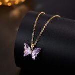 Niche ice translucent butterfly zircon jewelry set wholesale featuring carved crystal butterfly wings with marquise zircon bodies on a fine chain pendant necklace and matching stud earrings from junejewelry.com