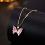 Niche ice translucent butterfly zircon jewelry set wholesale featuring carved crystal butterfly wings with marquise zircon bodies on a fine chain pendant necklace and matching stud earrings from junejewelry.com