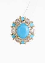 Niche vintage blue gemstone pearl jewelry set wholesale featuring an oval turquoise-blue cabochon surrounded by a halo of micro-pave zircons and turquoise accents on a pearl strand necklace with matching stud earrings from junejewelry.com